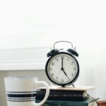 일상이 지치는 당신, 만성피로 벗어나는 생활 속 작은 변화들 white ceramic mug beside white and black analog alarm clock