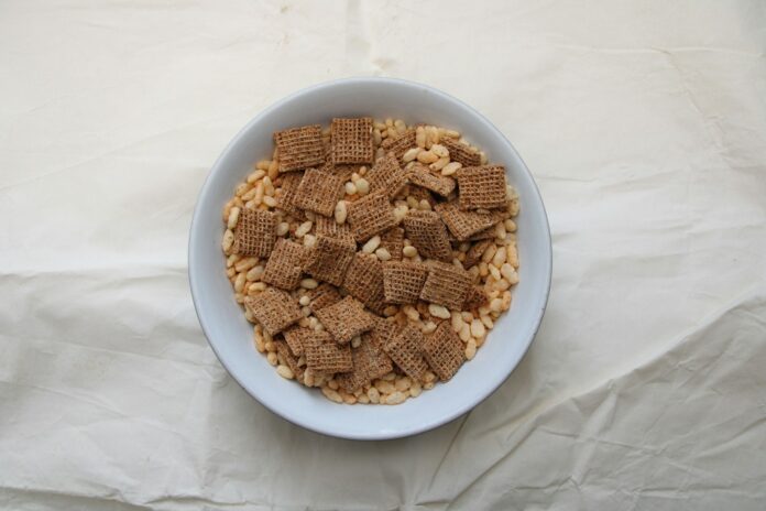 Photo by M Alazia a white bowl filled with cereal on top of a white table