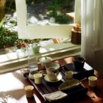 늘 피곤한 당신, 만성피로 극복 생활습관이 답이다 Tea set arranged on a wooden tray by the window.