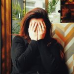 달라진 피로 관리법, 만성피로 벗어나는 현실 루틴 제안 woman in black long sleeve shirt covering her face